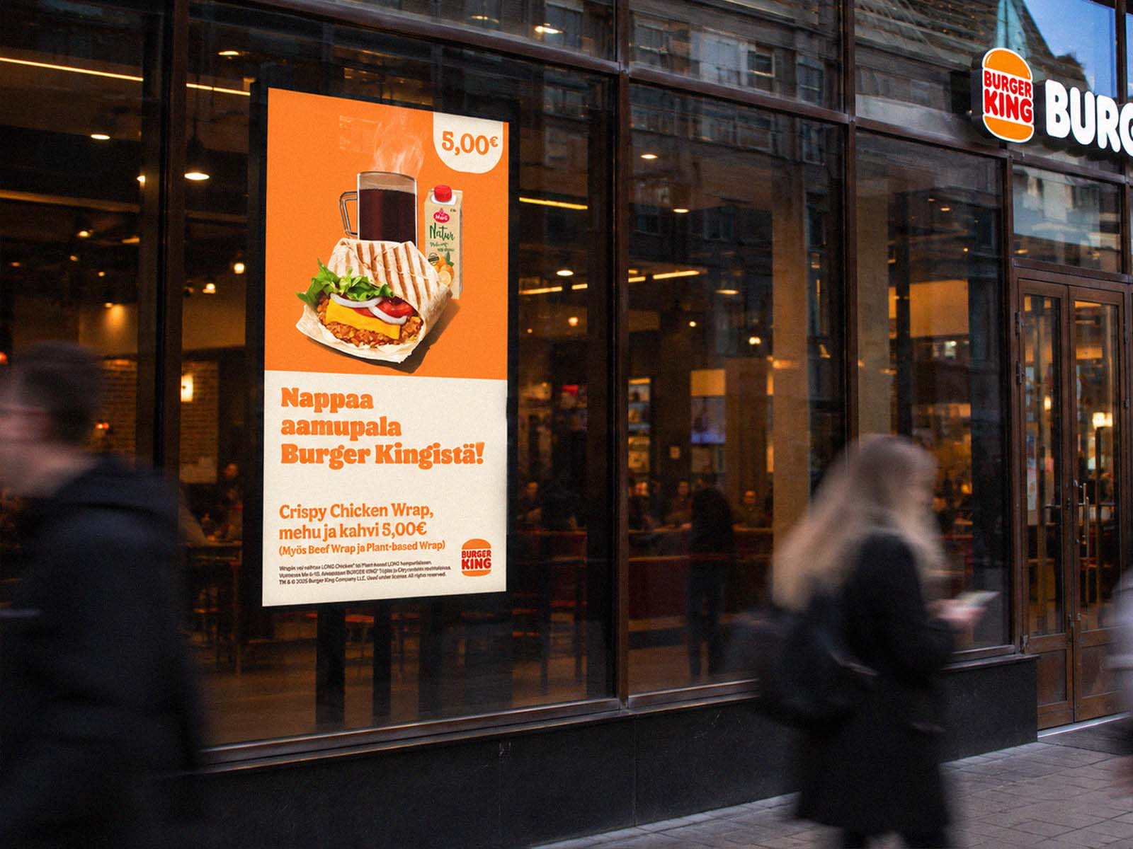 Burger King breakfast ad on a digital screen in a restaurant window